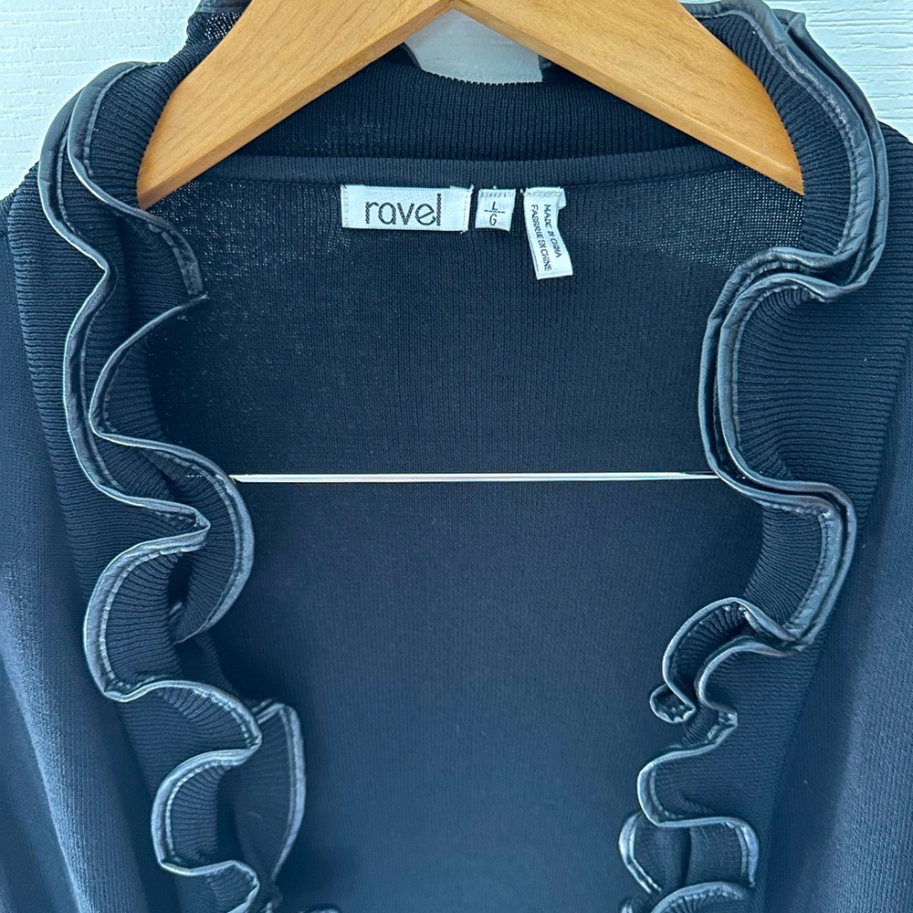Unique open black sweater with “leather” trim size large.